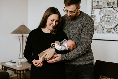 New parents holding their baby boy at home in Winnipeg