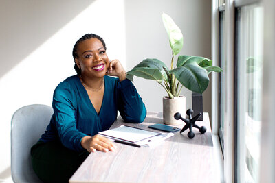 Florida Attorney Nequosha Anderson sitting at a desk in front of a window.