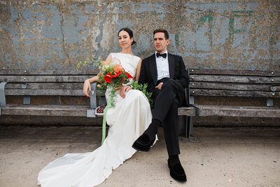 Bride laughing while walking down the aisle with her mom and dad