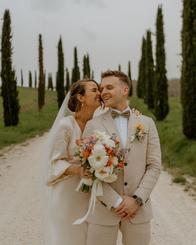 bride kissing grooms cheek
