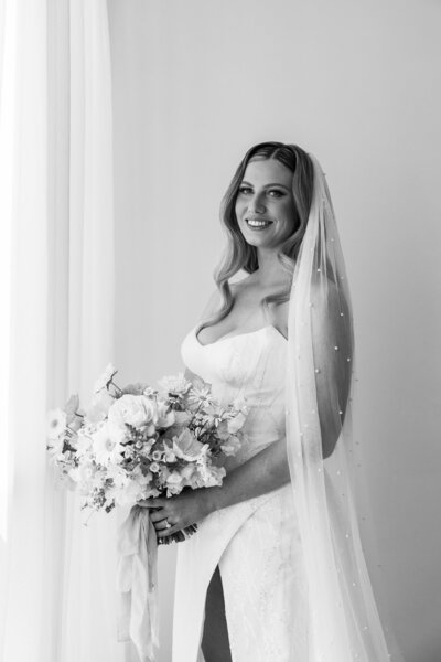 bridal prep photo with soft tucked waves and pink soft glam makeup