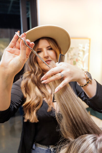 Hair Stylist cutting hair with scissors