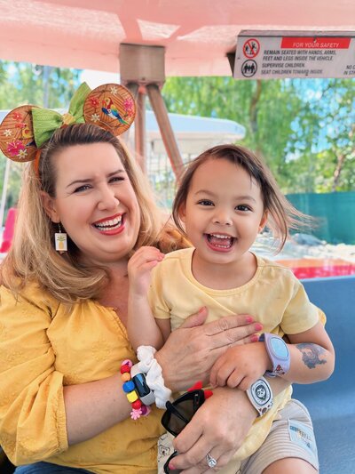 Caroline Morey Destination Wedding Photographer Disneyland Tram with daughter exuberant happy smiles happiest place on earth IMG_9308