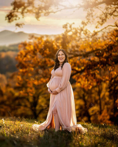 A beautiful mama to be showing her bump in the beautiful fall colors