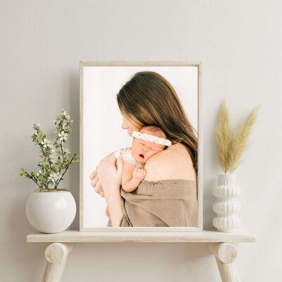 framed newborn photo of baby girl in mothers arm captured by Springfield MO newborn photographer The XO Photography