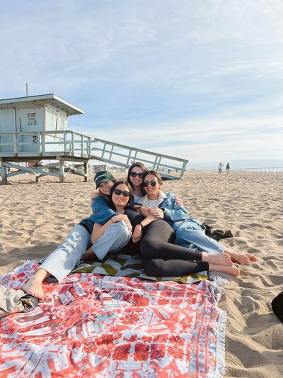 Image of friends smiling on the beach.