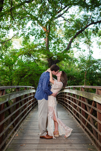 Sweet couple kissing on bridge in Dallas