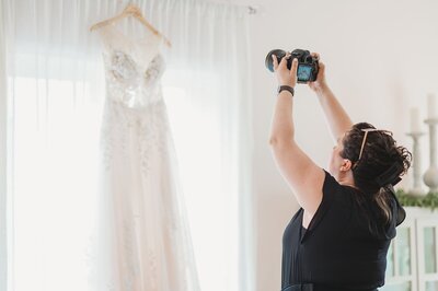 wedding photographer capturing wedding gown hanging up