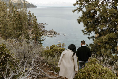 couple hiking down to the water in lake tahoe