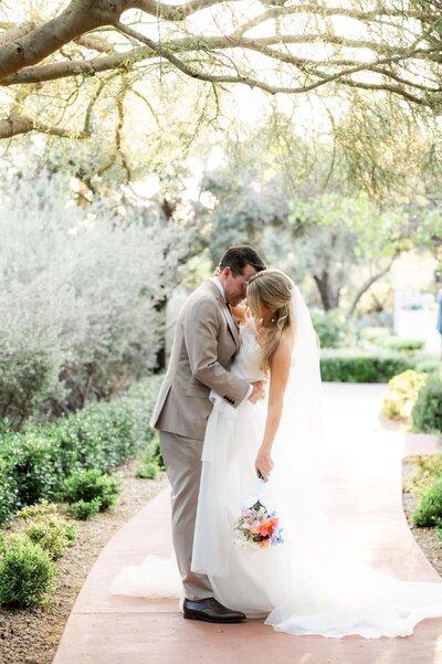 Bride and groom under trees on the path at EL Chorro