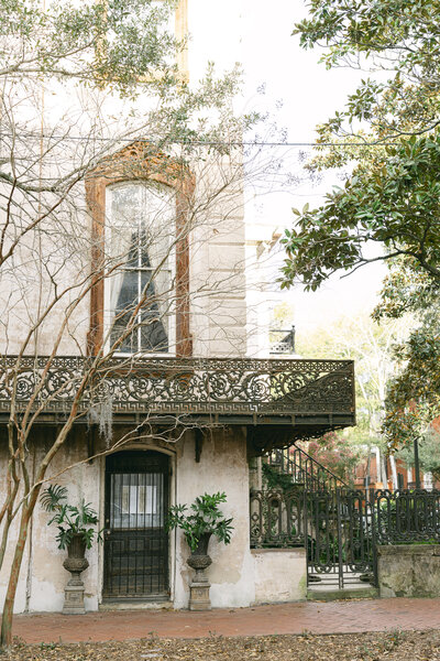 antique building with iron scroll work railings in downtown savannah captured by savannah wedding photographer magnolia west photography
