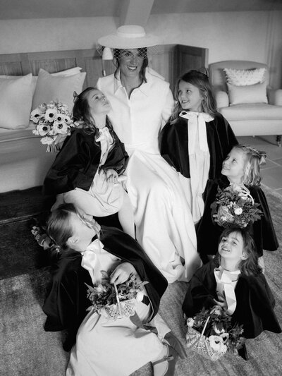 A bride and groom stopped in a field on their wedding day at Heckfield Place.