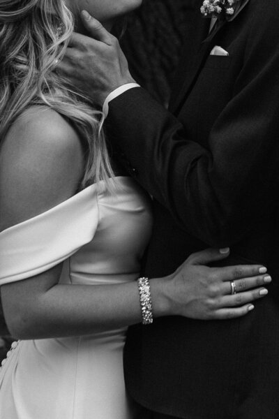 A close up view of two people with their arms wrapped around each other