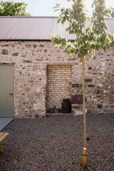 An old barn courtyard at Kinclune House is photographed. The space is newly renovated.