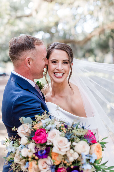 Couple with bright florals on their Savannah wedding day with Apt. B Photography