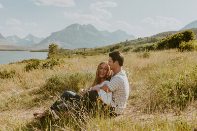 couple in a field in glacier national park in montana