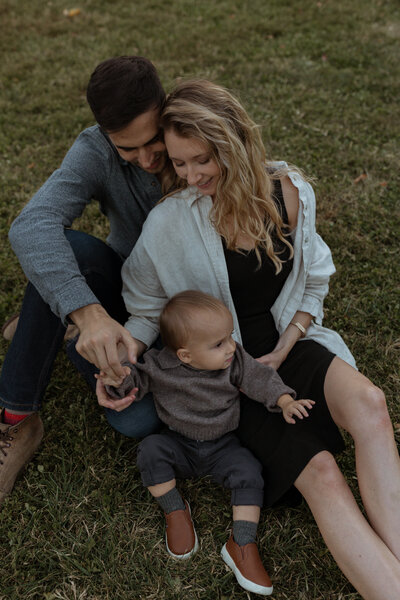 Tender close-up of a baby grasping their parent's shirt, showcasing the deep bond and warmth between mother and child in a natural, heartfelt moment