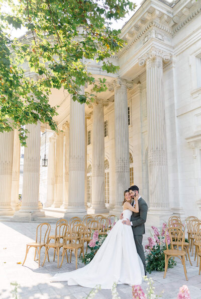 Bride and Groom taking portraits on the portico at DAR Constitution Hall in Washington DC. Captured by Washington DC Wedding Photographer Bethany Aubre Photography.