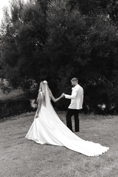 A vintage wedding portrait of a couple underneath the trees in Ohope. Captured by Eilish Burt Photography