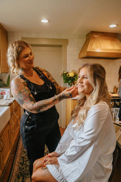 Libby a makeup artist in eugene applies makeup to a client.