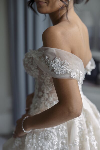 Detail of an off the shoulder lace dress. New England wedding photographer, Deborah Zoe Photography.
