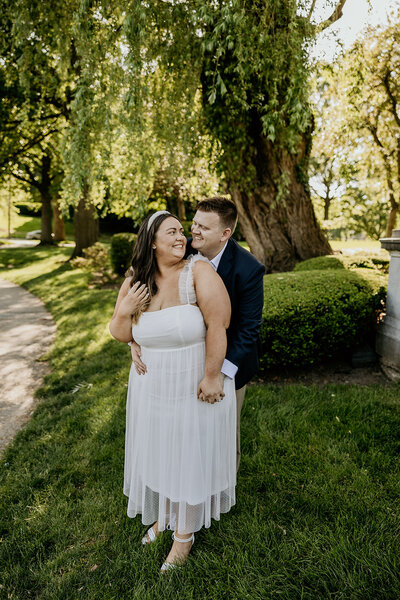 man and woman holding each other outside in beautiful engagement session in ohio