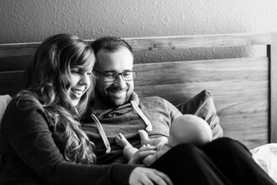 mom and dad admiring newborn