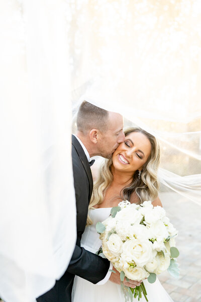 Bride and Groom Veil Kiss