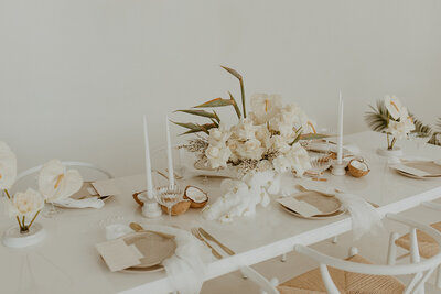 white tablescape with tropical flowers