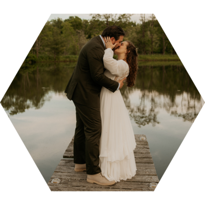 Bride & Groom in their wedding attire passionately kissing right after their cake cutting  at their wedding in Newport, Rhode Island