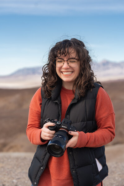 Stephanie Lamar smiling with a camera