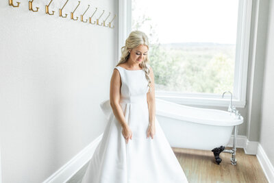 A bride in her dress in the bridal suite.
