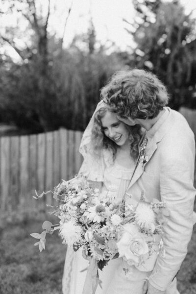 Peyton Curry and Jon share a candid moment during their backyard wedding in Richmond, Virginia, showcasing documentary-style wedding photography.