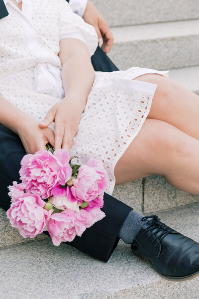 Couple sitting on the steps of the PA State Capitol in Harrisburg during their engagement session