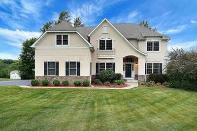 photo of white house with green landscaping