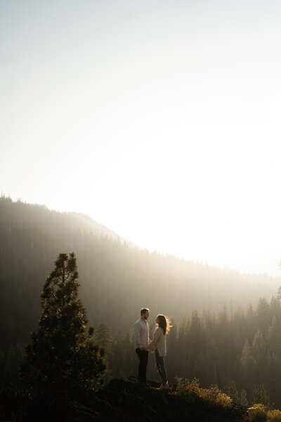Couple silhouetted against sunset.