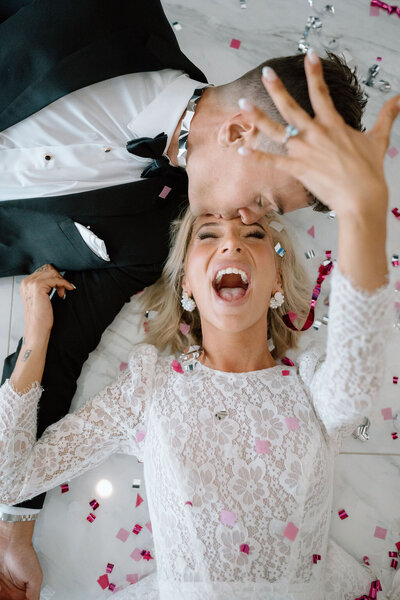 Boho couple in wedding dress with luxury flower bouquet.