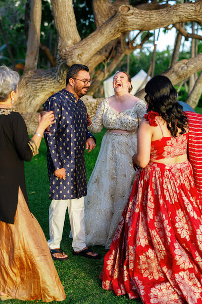 Newlyweds laughing with their wedding guests 