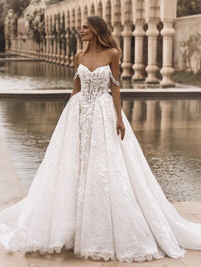 Bride in strapless ball gown with lace details.