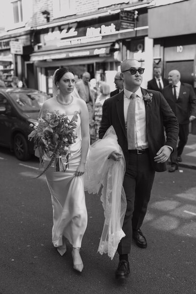 Wedding photographer captures couple taking a stroll hand in hand at their french chateau wedding.