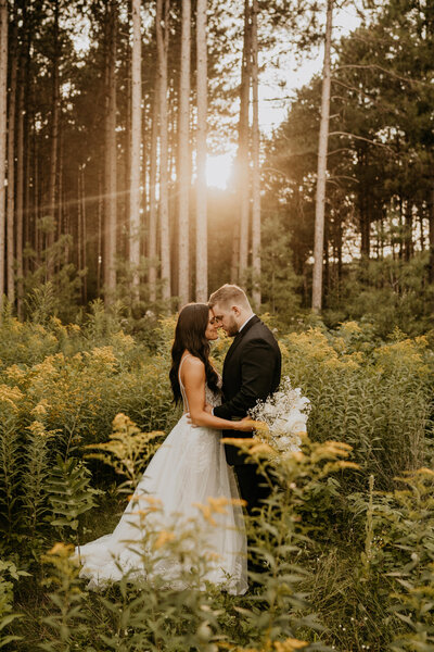 bride and groom in wildflowers