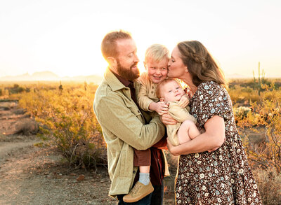 Parents with young kids laughing in Arizona during photography session