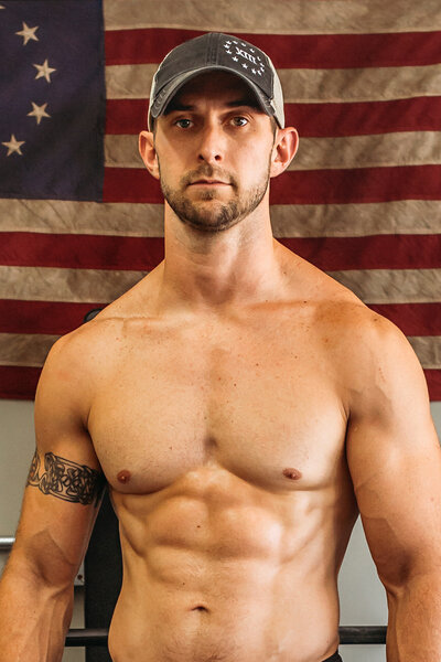 Joe Baker showcasing fitness transformation and strength-mindset journey with American flag backdrop | Joe Baker Fitness