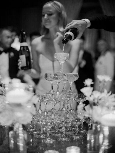 bride and groom popping champagne at their New York wedding reception captured by Sarah Anne Thompson