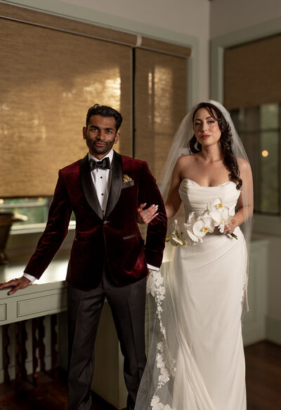 Bride and Groom in an editorial photo with velvet jacket and long veil at their romantic wedding planned by Everlasting Events