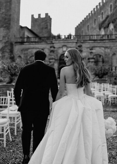 Couple kissing after slicing their wedding cake.