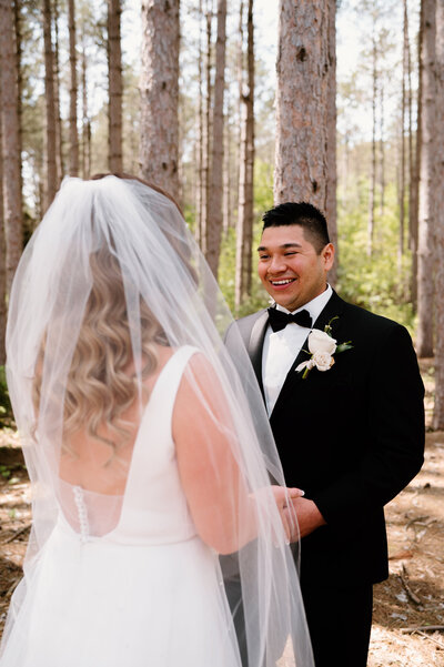 bride and groom smiling at each other