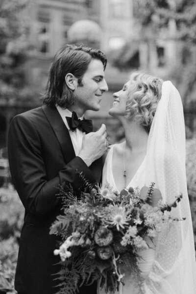 Kellen and Paul embracing during their intimate New York City wedding, captured in nostalgic black and white film by Editorial Wedding Co.