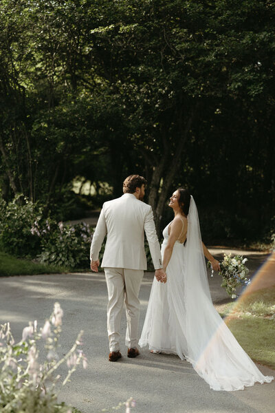 Intimate wedding portrait of a bride and groom sharing a quiet moment together in an outdoor setting