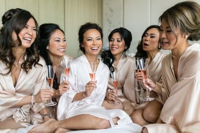 bridal party toasting with champagne after professional hair and makeup